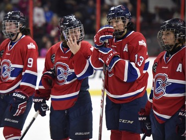Les Canadiennes de Montreal Kim Deschenes (9), Marie-Philip Poulin (29), Caroline Ouellette (13) and Ann-Sophie Bettez (24) stand after losing to the Calgary Inferno in Canadian Women's Hockey League final action at the Clarkson Cup, Sunday March 13, 2016, in Ottawa.