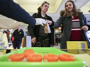 Kinsey Church, left, and Hannah Schneider, University of Ottawa students, part in the Pee to See Challenge at the University of Ottawa Tuesday, March 29, 2016. The challenge was aimed to break a Guiness World Record for the most Chlamydia and gonorrhea urine tests completed within 24 hours in a single venue.