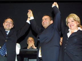 Jean Lapierre (centre) and wife Nicole Beaulieu acknowledge cheers along with Outremont Liberal MP Martin Cauchon, (left) at Lapierre's nomination meeting in Montreal, on Sunday, Feb.15, 2004. Lapierre, his wife and other members of his family died in a plane crash Tuesday.