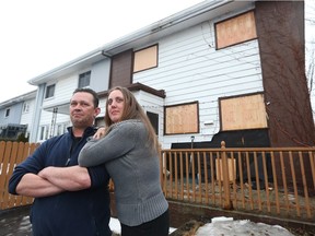 Guy and Cynthia Chartrand stand outside their neighbours burnt out house in Gatineau Quebec Monday March 28, 2016. Guy and Cynthis are upset that it took the fire department too much time to arrive at their friends place. The fire department went to the wrong house and the Chartrand's believe that their friends dogs would of been saved if they were at the right address.