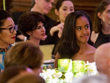 Malia Obama, right, next to actress Sandra Oh, left, listens as her father, President Barack Obama, receives a toast from Canadian Prime Minister Justin Trudeau during a State Dinner in the East Room of the White House in Washington, Thursday, March 10, 2016.