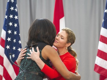 First lady Michelle Obama and Sophie Grégoire-Trudeau, wife of Canadian Prime Minister Justin Trudeau, hug while they participate in a program at the U.S. Institute of Peace in Washington, Thursday, March 10, 2016, to highlight Let Girls Learn efforts and raise awareness for global girl's education.