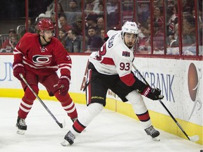 Ottawa Senators' Mika Zibanejad (93) handles the puck as Carolina Hurricanes' Noah Hanifin (5) watches during the first period of an NHL hockey game in Raleigh, N.C., Tuesday, March 8, 2016.