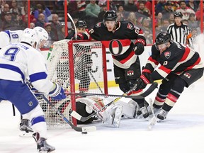 Mike Hoffman and Dion Phaneuf attempt to stop the puck but with Hammond lying down in the net it was an easy chip in for Ondrej Palat (L) for the second goal in the second period as the Ottawa Senators take on the Tampa Bay Lightning in NHL action at the Canadian Tire Centre in Ottawa.
