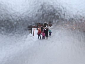 Freezing rain fell over night causing school buses to be cancelled in Ottawa Monday Feb 29, 2016. Families walk their kids to school on Smyth Road Monday morning. Tony Caldwell