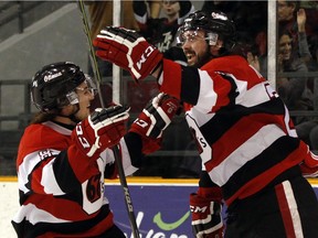 The Ottawa 67's Ben Fanjoy, left, and Jacob Middleton celebrate after Middleton scored in the first period against the Hamilton Bulldogs at TD Place arena on Friday, March 18, 2016.