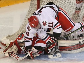 The Ottawa 67's took on the Niagara IceDogs during game four of the OHL playoffs at TD Place in Ottawa Ontario Wednesday March 29, 2016.  67's goalie Leo Lazarev gets run over by IceDogs forward Brendan Perini during second period action in Ottawa Wednesday.    Tony Caldwell