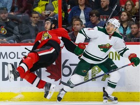 Ottawa Senators center Mika Zibanejad (93) gets upended by Minnesota Wild right wing Justin Fontaine (14) during NHL hockey action at the Canadian Tire Centre in Ottawa on Tuesday March 15, 2016. Errol McGihon