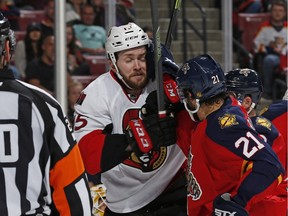 Vincent Trocheck #21 of the Florida Panthers and Zack Smith #15 of the Ottawa Senators tangle in front of the net during second period action at the BB&T Center on March 10, 2016 in Sunrise, Florida.
