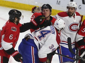 The Ottawa Senators' Dion Phaneuf and the Montreal Canadiens' Michael McCarron have a difference of opinion at the Canadian Tire Centre on Saturday, March 19, 2016.  Back when the season began, neither team expected to be where it was in the standings entering the game.