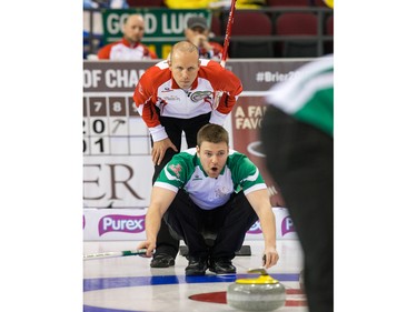 Pat Simmons of Team Canada looks over the shoulder of Kirk Muyres as the Tim Horton's Brier continues on Sunday at TD Place in Ottawa.