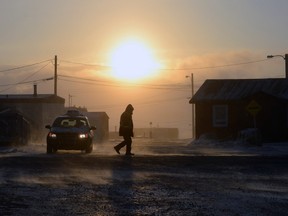 People make their way through the -46 C with wind chill temperatures in Iqaluit, Nunavut on Monday, December 8, 2014.
