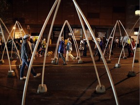 People walk through archways on George Street during the 2014 Nuit Blanche in Ottawa.