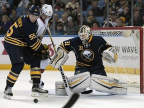 Buffalo Sabres defenceman Rasmus Ristolainen tangles with Ottawa Senators right-winger Alex Chiasson as Sabres goaltender Chad Johnson makes a save during the second period Friday, March 18, 2016, in Buffalo.