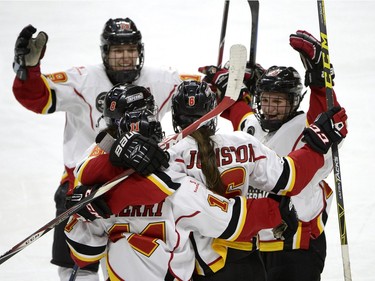 The Calgary Inferno celebrate the empty net goal of Rebecca Johnston (6) against Les Canadiennes de Montreal during the third period of Canadian Women's Hockey League final action at the Clarkson Cup, Sunday March 13, 2016, in Ottawa.