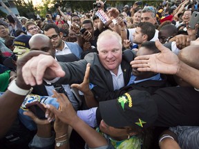 Toronto's then-mayor, Rob Ford, makes his way through thousands of people at Ford Fest in Toronto on July 25, 2014.