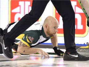 Northern Ontario third Ryan Fry watches his shot during a draw against Quebec at the Tim Hortons Brier, Sunday March 6, 2016, in Ottawa.