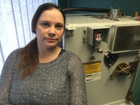 Sam Newman-Corrigall, operations manager for Power Systems Technology, poses with one of the company's electrical transformers. The company accuses Hydro Ottawa of unethical business practices and has complained to the Competition Bureau.