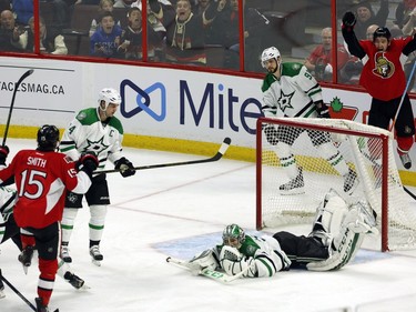 Dallas Stars' goalie Kari Lehtonen (32) lies on the ice as Ottawa Senators' Zak Smith and teammate Mark Stone (61) celebrate after Smith scored during second period NHL hockey action, in Ottawa on Sunday, Mar. 6, 2016.