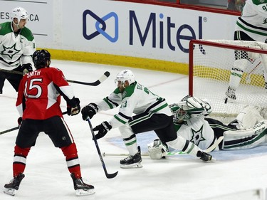 Dallas Stars' goalie Kari Lehtonen (32) looks back from laying on the ice as Ottawa Senators' Zak Smith (15) scores during second period NHL hockey action, in Ottawa on Sunday, Mar. 6, 2016.