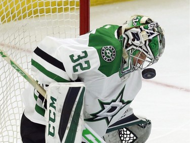 Dallas Stars' goalie Kari Lehtonen (32) takes a puck to the cage during first period NHL hockey action against the Ottawa Senators, in Ottawa on Sunday, Mar. 6, 2016.