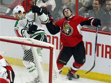 Ottawa Senators' Jean-Gabriel Pageau (44) reacts after being checked by Dallas Stars' Antoine Roussel (21) during third period NHL hockey action, in Ottawa on Sunday, Mar. 6, 2016. Dallas beat Ottawa 2-1.