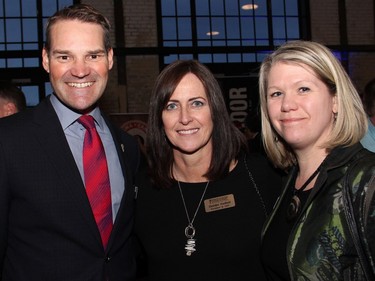 Shepherds of Good Hope president and CEO Deirdre Freiheit is flanked by its foundation's board members, Ryan Kilger and Doreen Hume, a partner at Deloitte who's also a long-time board member with the non-profit organization, at a culinary benefit held at the Horticulture Building at Lansdowne on Wednesday, March 30, 2016.