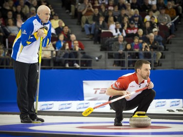 Alberta skip Kevin Koe looks on as Newfoundland and Labrador skip Brad Gushue studies the line of an incoming rock during the championship game at the Tim Hortons Brier at TD Place arena on Sunday, March 13, 2016.