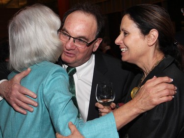 Supreme Court of Canada Chief Justice Beverley McLachlin gets a hug from her colleague, Justice Michael J. Moldaver, joined by his wife, Riky, at a reception to celebrate the presentation of the Key to the City to McLachlin at Ottawa City Hall.