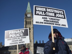 Taxi drivers protest against the ride sharing service Uber during a rally on Parliament Hill, Tuesday, February 2, 2016 in Ottawa.