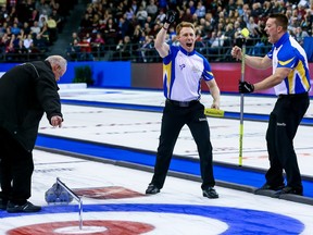 Team Alberta third Marc Kennedy and lead Ben Hebert, right, celebrate their victory over Team Northern Ontario after an official's deciding measurement in the 10th end of the Brier semifinal at TD Place arena in Ottawa on Saturday, March 12, 2016.