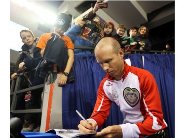 Team Canada Skip Pat Simmons signs autographs for kids after the Tim Hortons Brier opening ceremony, March 05, 2016.