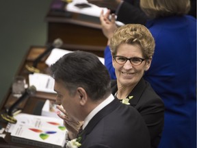 Premier Kathleen Wynne applauds the 2016 budget, which helps poorer students with tuition.