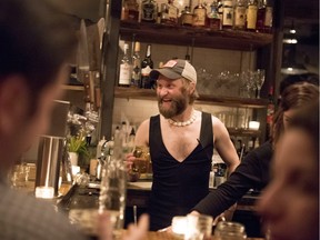 Union 613 co-owner Ivan Gedz works behind the bar while wearing a low cut top, during an event highlighting sexist dress codes and discrimination against women in the service industry,