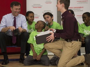 Finance Minister Bill Morneau provided a sneak preview of the new shoes he'll be sporting during a pre-budget photo-op in Toronto last week. (Tyler Anderson / National Post)