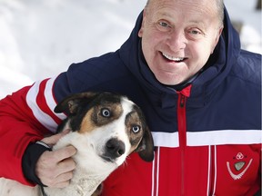 U.S. Ambassador Bruce Heyman poses for a photo with Jackson, one of the dogs at  Timberland Tours.