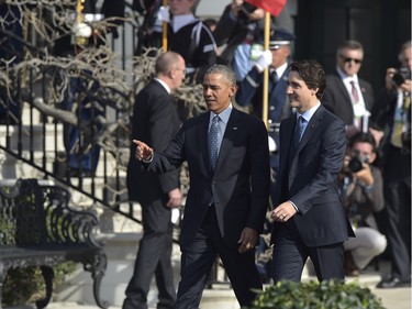 US President Barack Obama and Canada's Prime Minister Justin Trudeau arrive to take part in a welcome ceremony during a State Visit on the South Lawn of the White House on March 10, 2016 in Washington, DC. /