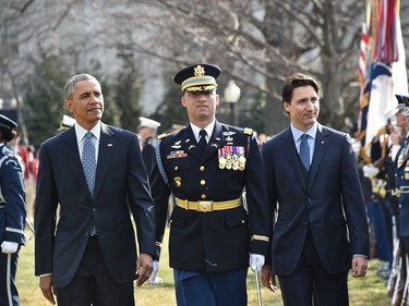 US President Barack Obama and Canada's Prime Minister Justin Trudeau take part in a welcome ceremony during a State Visit on the South Lawn of the White House on March 10, 2016 in Washington, DC. /