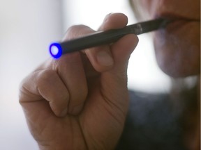 This 2013 file photo illustration shows a woman smoking an "Blu" e-cigarette (electronical cigarette).