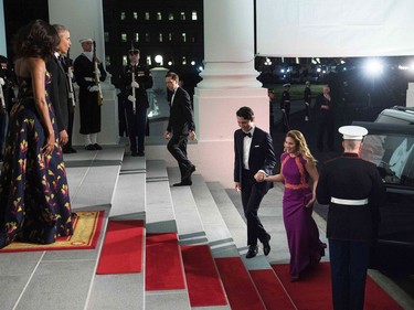 US President Barack Obama and first lady Michelle Obama greet Canadian Prime Minister Justin Trudeau and Sophie Gregoire-Trudeau before a state dinner at the White House March 10, 2016 in Washington, DC. /