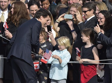 Canada's Prime Minister Justin Trudeau greets visitors as he takes part in a welcome ceremony during a State Visit on the South Lawn of the White House on March 10, 2016 in Washington, DC. /