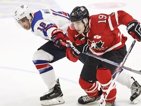 USA'S Colin White, left,  and Canada's Brayden Point vie for the puck during the 2016 IIHF World Junior Ice Hockey Championship match between USA and Canada in Helsinki, Finland Saturday, Dec. 26, 2015.