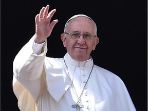 Pope Francis waves to the crowd after the "Urbi et Orbi" blessing for Rome and the world from the central loggia of St Peters' basilica following the Easter Sunday mass on March 27, 2016 at St Peter's square in Vatican. Christians around the world are marking the Holy Week, commemorating the crucifixion of Jesus Christ, leading up to his resurrection on Easter.