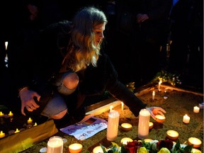 LONDON, ENGLAND - MARCH 24: A mourner lights a candle in Trafalgar Square during a candlelit vigil in support of the victims of the recent terror attacks in Brussels on March 24, 2016 in London, England. Belgium is observing three days of national mourning after 34 people were killed in a twin suicide blast at Zaventem Airport and a further bomb attack at Maelbeek Metro Station. Two brothers are thought to have carried out the airport attack and an international manhunt is underway for a third suspect. The attacks come just days after a key suspect in the Paris attacks, Salah Abdeslam, was captured in Brussels.