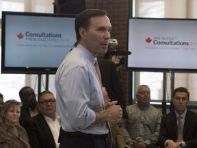 Minister of Finance Bill Morneau rolls up his sleeves for a town hall meeting in Ottawa on Feb. 22.