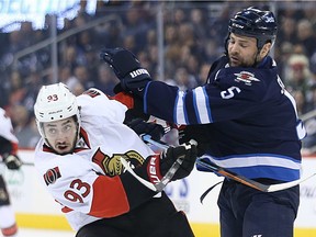 Winnipeg Jets defenceman Mark Stuart (right) steps into  Ottawa Senators centre Mika Zibanejad during NHL action in Winnipeg on Wed., March 30, 2016. Kevin King/Winnipeg Sun/Postmedia Network