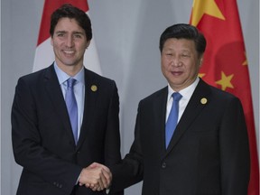 Prime Minister Justin Trudeau is greeted by Chinese President Xi Jinping as they take part in a bi-lateral meeting at the G20 Summit in Antalya, Turkey on Monday, November 16, 2015. Is Ottawa just giving in and siding with Beijing these days? wonders Terry Glavin. THE CANADIAN PRESS/Sean Kilpatrick