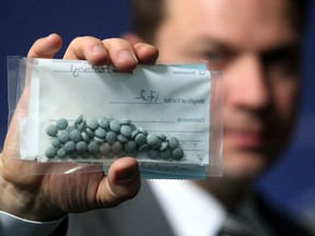 Calgary Police Service Staff Sgt. Martin Schiavetta, of the CPS Drug Unit, held an evidence bag with seized Fentanyl tablets during a press conference to raise awareness around the street drug on March 25, 2015.