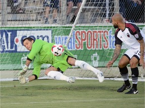 Ottawa Fury FC goalkeeper Romuald Peiser dives to make an early save against the Carolina RailHawks on Saturday, April 16, 2016 in Cary, N.C.