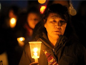 A candlelight prayer vigil was held as darkness fell over Attawapiskat, April 15, 2016).